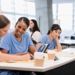 Two miramar ASN nursing school students co-operate on classwork