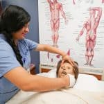 home health aide training program student in Miramar practicing with mannequin