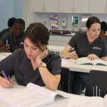 miramar ASN nursing school students reading their notebooks -studying for the nclex-rn in the classroom