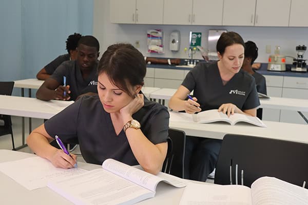 miramar ASN nursing school students reading their notebooks -studying for the nclex-rn in the classroom