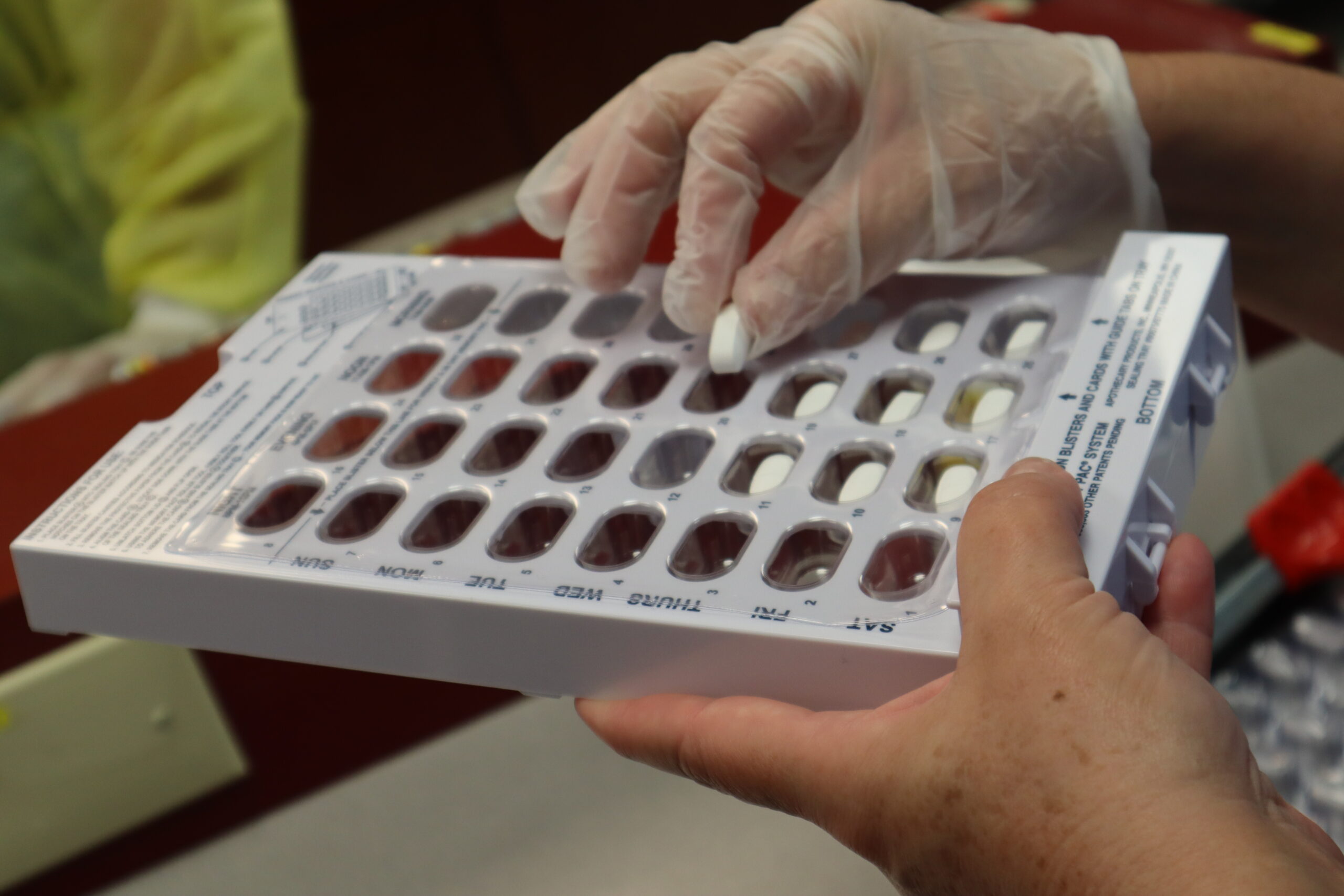 An FVI miami pharm tech school student practicing dispensing drugs
