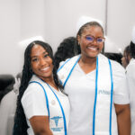 Two smiling FVI miramar ASN nursing program student nurses after pinning ceremony