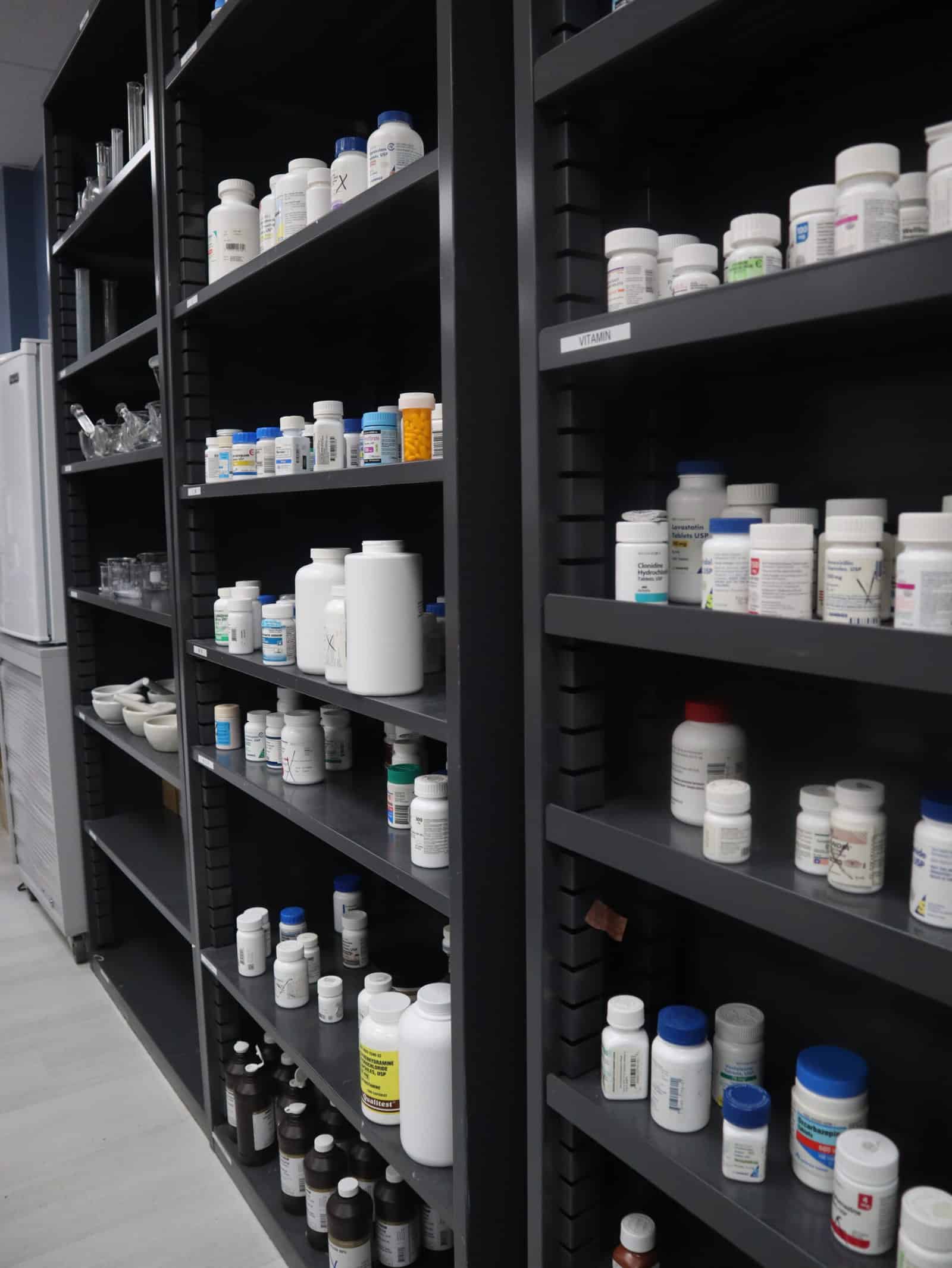 A picture of the shelves inside the FVI miami pharmacy technician school lab showing bottles of pills