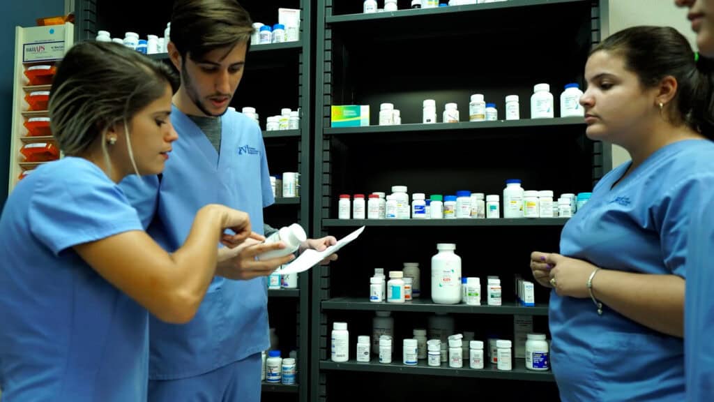 Miami Pharmacy technician program students practicing in FVI's pharmacy lab