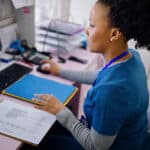 flordida nurse working at the reception desk in the private clinic