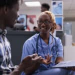 florida nurse consulting patient at clinic