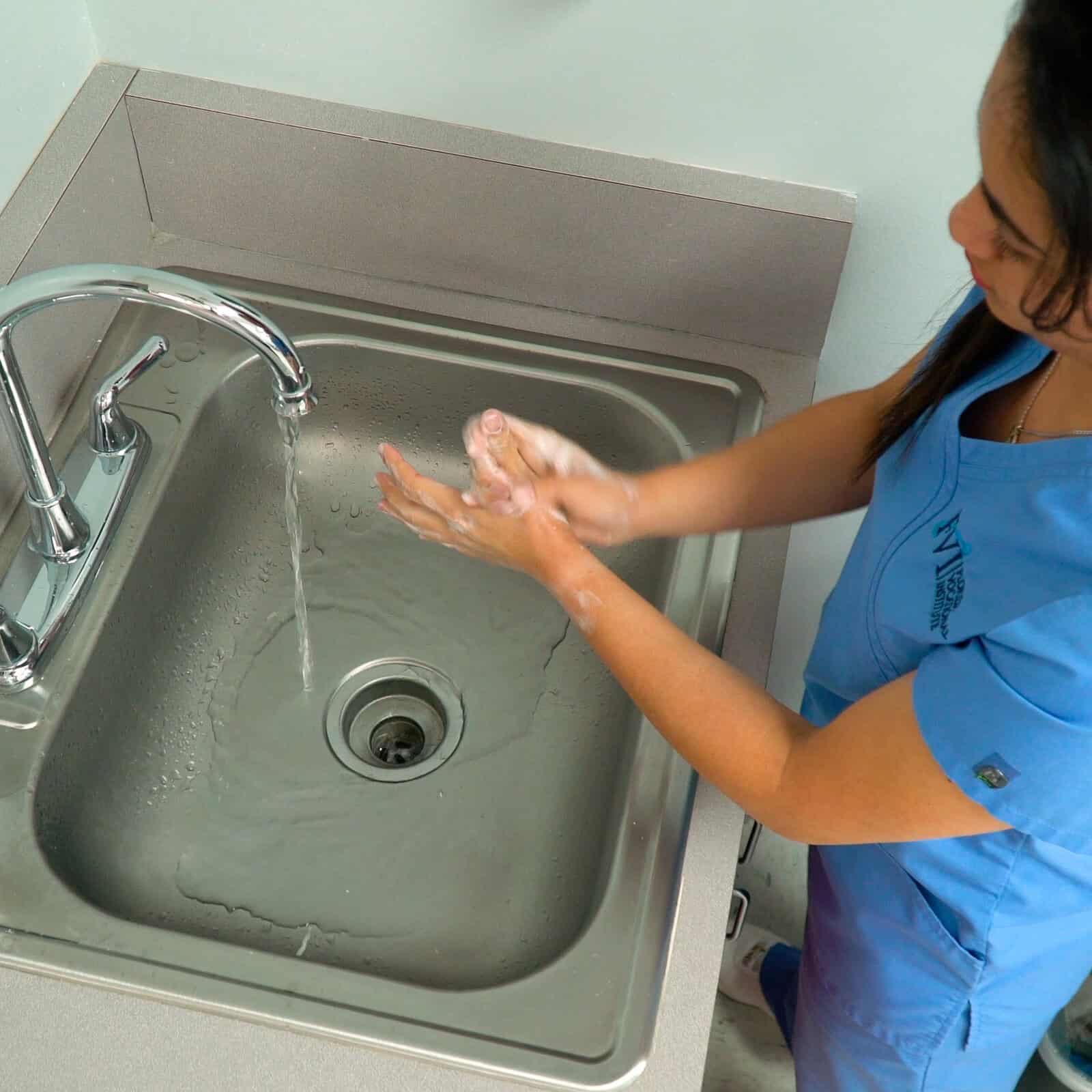 Miami home health aide program student washing her hands