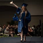 happy graduate walking down the stage during graduation