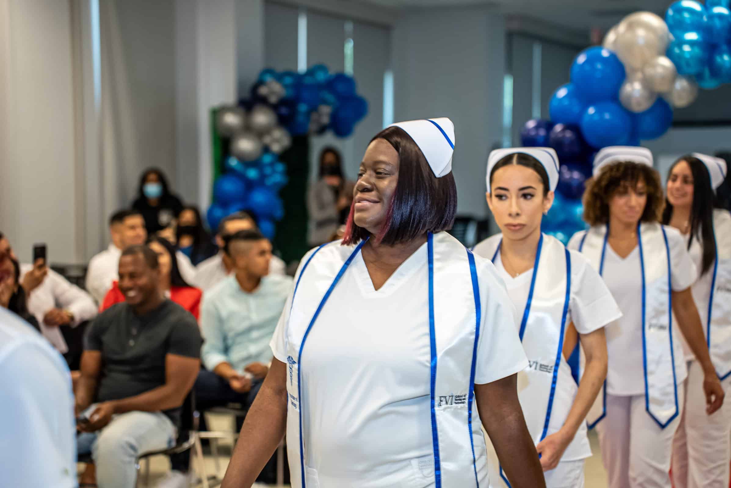 FVI Miami ASN nursing degree program graduates walking into their Pinning Ceremony