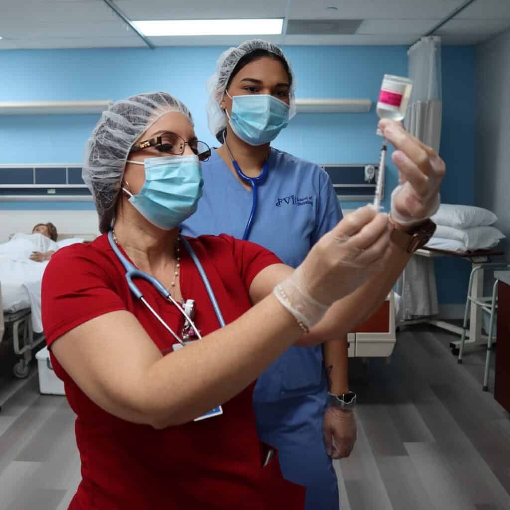 instructor showing miramar nursing school student how to set up an injection