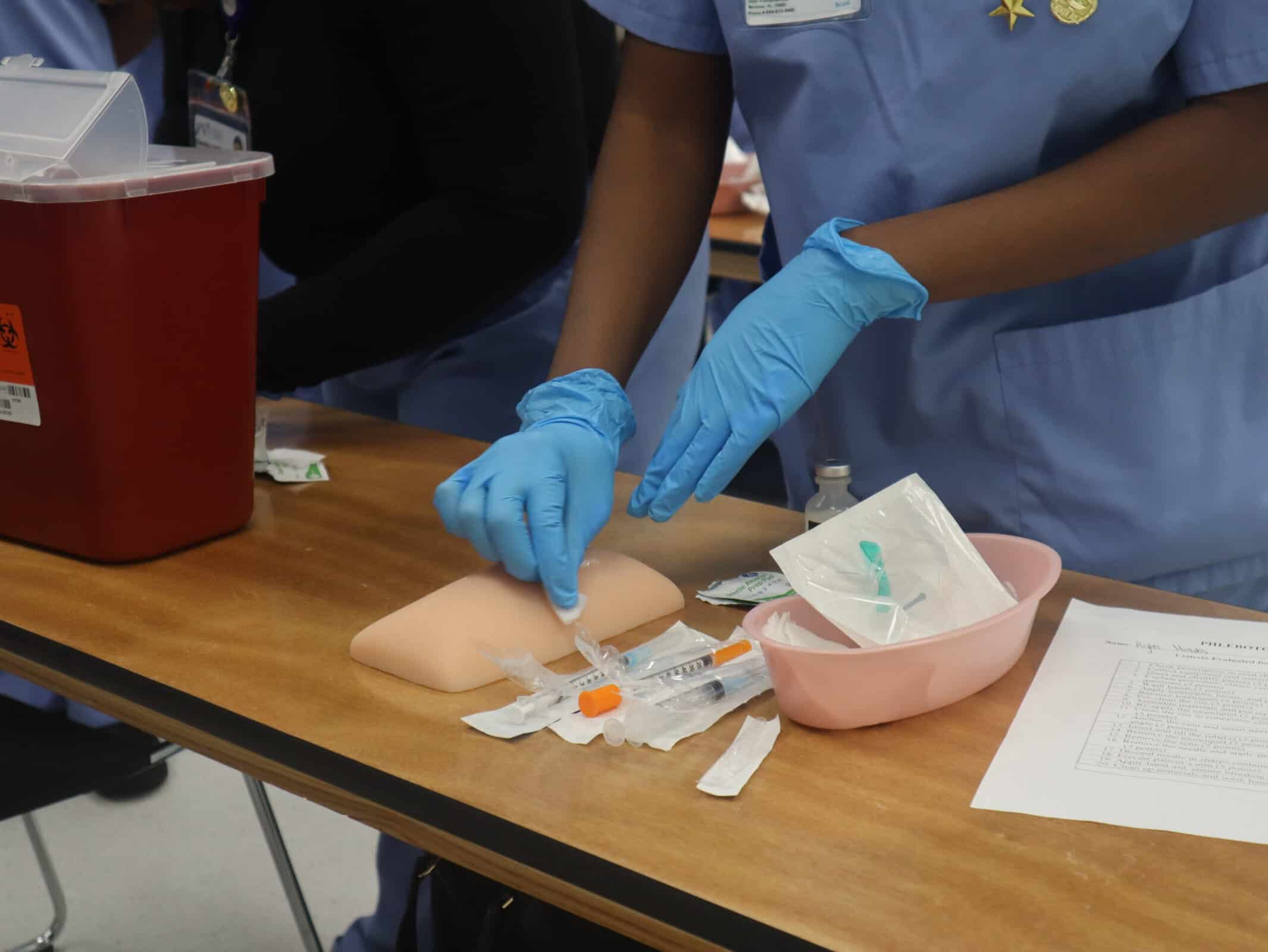 A miramar allied health program student doing hands-on practice in class