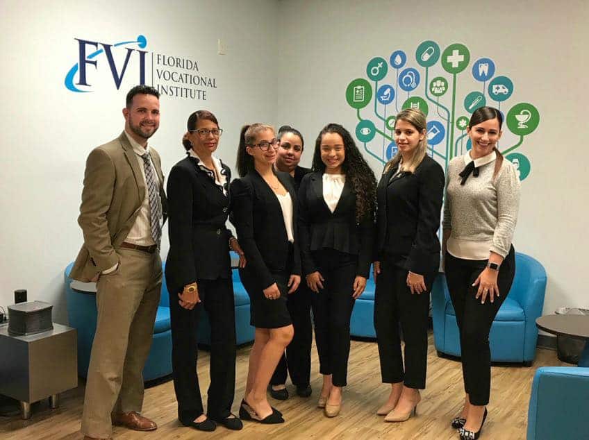 The career services team meeting with employers in the lobby of the Miami campus