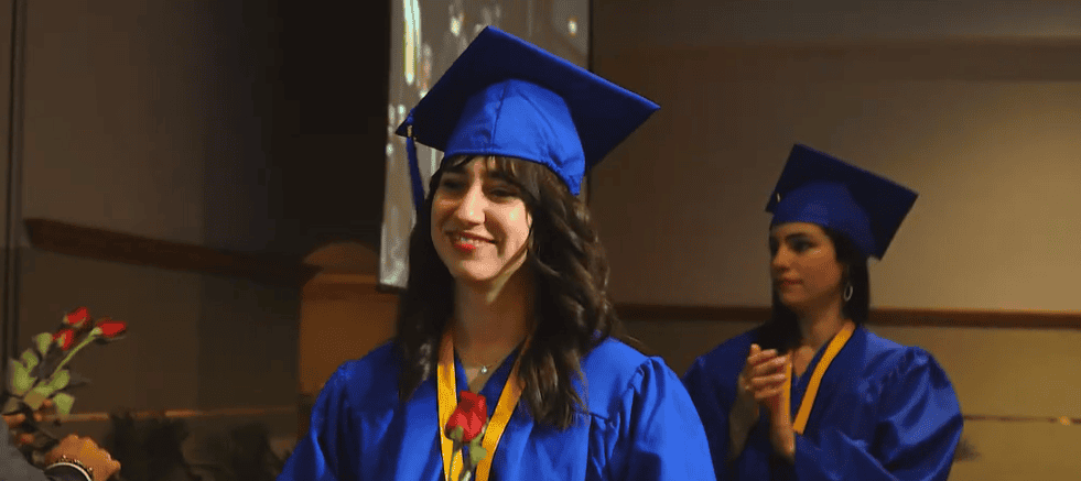 Diana Puentes - Miami Patient Care Technician school graduate: student walking down stage