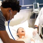 Miami ASN nursing school students hands on skills: taking patient vitals