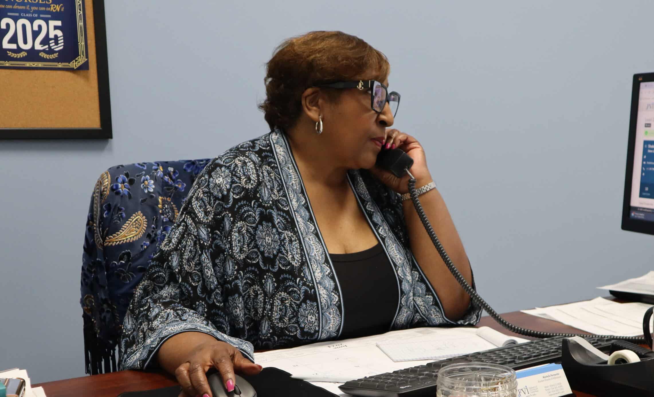 An FVI nursing school admissions rep on the phone with a student