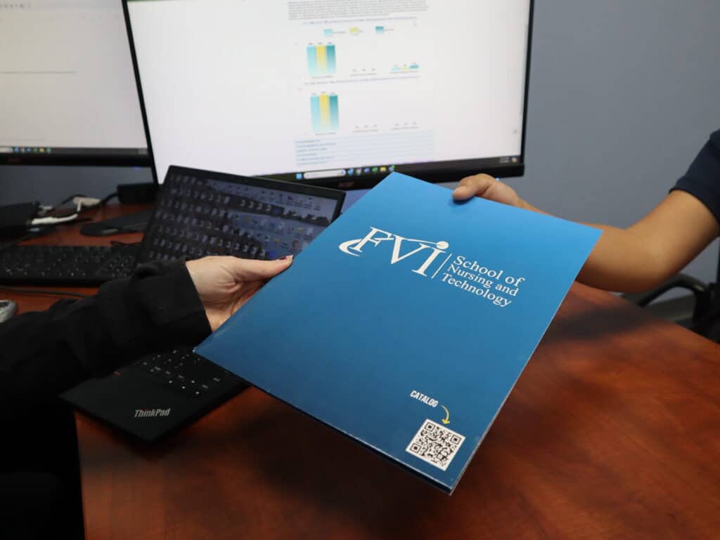 FVI nursing school admissions rep handing a student an FVI flyer