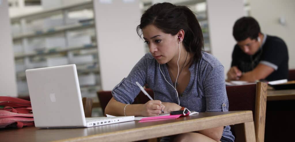 allied health student studying and looking at her laptop