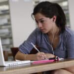 allied health student studying and looking at her laptop