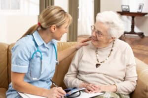 home health aide working with elderly woman