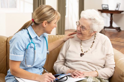home health aide working with elderly woman