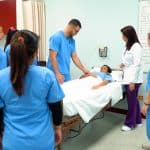 practical nursing school students in Miami - hands on practical nursing classes - students practicing their skills